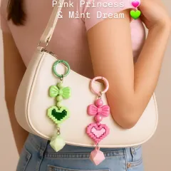 Your bag needs a glow up, and these pixel heart charms are it. This is the ultimate Gen Z vibe, shown here on a classic white shoulder bag. Choose between Pink Princess and Mint Dream to match your aesthetic.