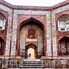The imposing entrance gate to the Humayun's Tomb complex. The use of red sandstone and white marble, along with the grand scale, sets the stage for the architectural marvel within.