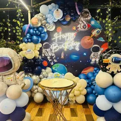 A "First Trip Around the Sun" space theme, perfect for a baby's first birthday. This detailed setup includes a galaxy backdrop, planet and astronaut cutouts, a custom neon sign, and a full balloon arch creating an out-of-this-world celebration.