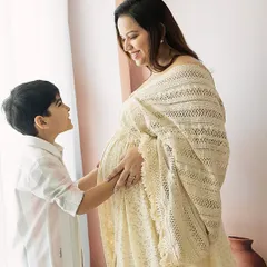 The look of love between a mother and her firstborn as they anticipate the new baby. The soft, natural light adds to the warmth of the scene.
