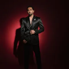 A powerful portrait of Ayushmann Khurrana for a Pinkvilla style feature. The dramatic red background and sharp lighting create a bold, memorable image.