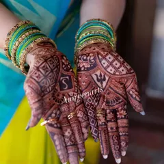 The beautiful contrast between the dark henna stain and the bride's vibrant attire. This is the color you can expect from my work.