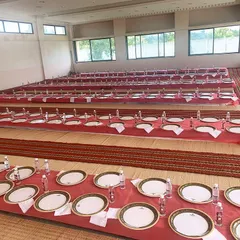 A wide view of the traditional floor seating arrangement I set up for the event at the madrasa. Every detail is taken care of to ensure a comfortable and organized dining experience.