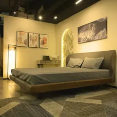 A modern bedroom display at the Experience Centre, showcasing a low-profile bed, curated artwork, and a mix of textures that you can see and feel up close.