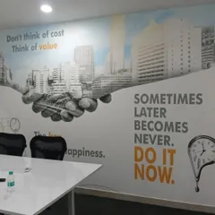 I combine powerful quotes and cityscape graphics to create a dynamic and motivating atmosphere in this corporate meeting room. The design reinforces key business messages like "Think of value" and "Do it now" to drive performance.