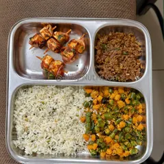 Who says healthy can't be exciting? This plate features delicious paneer skewers, offering a fantastic source of protein, alongside seasoned rice and a mix of vibrant, fiber-rich vegetables. It’s a perfect example of how I make nutritious food that you'll genuinely look forward to eating.