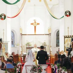 A classic church wedding scene, with the couple at the altar before the priest and their loved ones. I coordinate with venues of all kinds, including places of worship, to ensure a seamless ceremony.