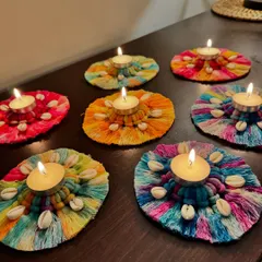 Light up your home for Diwali with these vibrant, multi-colored macrame diya holders. They are decorated with cowrie shells for a traditional touch and look so beautiful when lit.