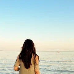 Looking out at the endless horizon, enjoying a peaceful moment at the beach.