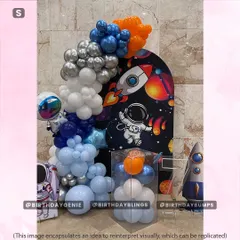 A more vibrant and graphic space theme, featuring a rocket blasting off on the backdrop and a dynamic silver, blue, and orange balloon arrangement.