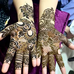 A gorgeous floral design with a mix of bold roses and delicate leafy patterns. The contrast between the two hands adds a modern touch.