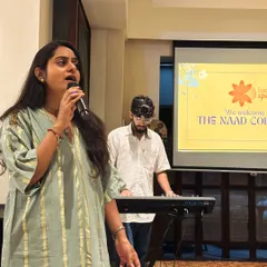 A member of The Naad Collective sings with confidence, accompanied by a keyboardist. Our events provide a platform for everyone to share their love for music.