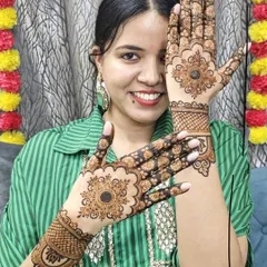 A happy client showing off her Karwa Chauth mehndi. The design features classic mandala patterns, perfect for festive occasions when you want something traditional and beautiful.