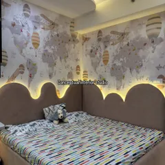 The cloud-shaped headboard with integrated backlighting creates a dreamy and magical ambiance in this child's bedroom.