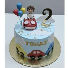 Zooming into 2! This sweet, sky-blue vanilla cake with fresh whipped cream was specially crafted for Yunay's birthday. Topped with a little driver, fun cars, and fluffy clouds.