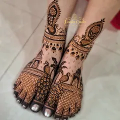 A unique feet mehendi design featuring peacocks and palm trees, perfect for a beach wedding or a bride who loves tropical vibes.
