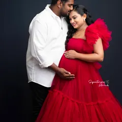 A tender moment between the couple, with the rich red of the gown adding a touch of romance and passion to the portrait.