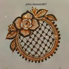 This is a demonstration of a mandala design that incorporates a net or grid pattern, known as a 'jaali'. The design is framed with a beautiful rose and leaves, combining geometric and floral elements.