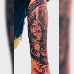 This full forearm sleeve features the Ardhanarishvara, representing the divine union of Shiva and Parvati. We designed this piece to flow with the arm's anatomy, incorporating elements like the Om symbol and 'Jai Shiv Shakti' script. It's a powerful piece of spiritual art that tells a story.