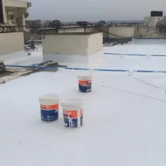 A member of my team is applying the final white waterproof layer using a roller. This ensures a smooth, uniform finish and is a critical part of my start-to-finish waterproofing service.