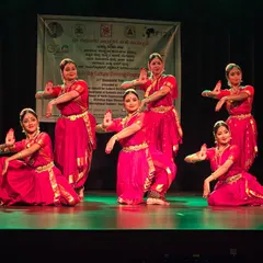 Our group presenting a traditional piece at the Friday Cultural Programme. The matching red costumes and synchronized poses create a powerful visual impact on stage.