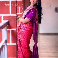 A full-length shot of a client in a stunning pink and purple saree for her reception. The makeup is polished and elegant, perfect for an evening of celebration.
