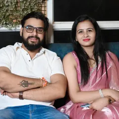 A relaxed portrait of a couple sitting together at a family event.