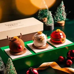A trio of exquisite Christmas-themed entremets, shaped like a reindeer, a snowball, and Santa's belly. These individual desserts showcase my detailed patisserie work and are perfect for an elegant holiday dessert table.