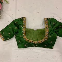 A beautiful bottle green blouse with a sweetheart neckline and delicate buttis embroidered all over.