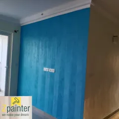 This accent wall combines texture with a pattern. We created subtle vertical stripes using a dragging technique on a vibrant blue wall, adding both color and a unique tactile dimension.