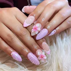Dive into detail with our mermaid-inspired 3D nail art. This set features soft lavender gel extensions with intricate seashell textures and delicate, hand-sculpted flowers. It’s a whimsical yet elegant design that showcases our expertise in creating unique, dimensional nail art.
