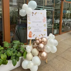 A personalized welcome sign for the baby shower, adorned with a small balloon cluster that matches the main decor. It's the first thing guests see and sets the tone for the event.