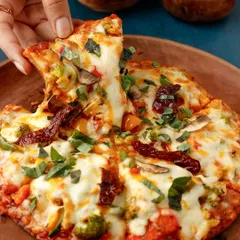Nothing sells a pizza like the perfect cheese pull. This shot is all about capturing that satisfying, delicious moment that everyone loves, making it an essential photograph for any pizzeria's menu or social media.