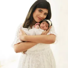 There is nothing more precious than the first few weeks with your newborn. This portrait captures the serene, gentle love of a mother holding her new baby close.