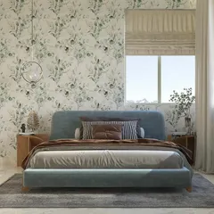 A centered shot of the minimalist bed, highlighting its clean lines and the gentle texture of the fabric. The simple wooden side table and glass pendant light complete the uncluttered, peaceful aesthetic.