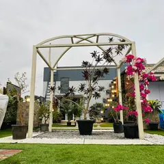 This simple yet elegant arched pergola serves as a beautiful frame for a garden pathway and entrance. We trained vibrant bougainvillea to climb the structure, adding a splash of color and natural beauty to the hardscaped arch.