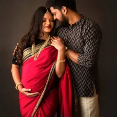 I had the absolute honor of capturing this tender moment between two renowned photographers. This traditional couple's maternity portrait, with them in a beautiful red saree and kurta, shows the deep connection and quiet joy of expecting parents.