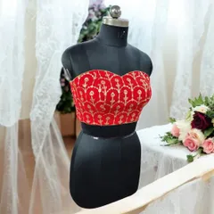 This red brocade bustier is a perfect example of our designer blouses. Whether you prefer ready-made styles or a custom fit, this piece adds a touch of regal charm to any ethnic ensemble.