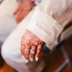 A beautiful detail shot of the groom's cuff, embroidered with their wedding date. It's these personal touches that make a wedding story unique and memorable.