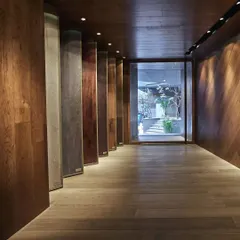 An 'experiential thoroughfare' at the FCML wood floor showroom in Delhi. This long, linear space allows customers to walk through and interact with over 200 types of wood flooring displayed in unconventional ways.