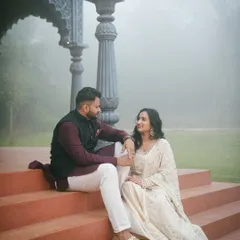 This wider angle shows how the steps lead up to the main structure, offering different levels and angles for photography. The couple is surrounded by the misty garden, creating a serene atmosphere.