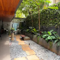 A pathway made of gravel and stone pavers creates a beautiful texture contrast in this garden. We used a mix of low-growing plants and taller trees to create a sense of discovery as you walk through the space.