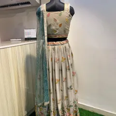 This lightweight lehenga in a subtle grey tone features delicate, colorful leaf embroidery. It's an understated and elegant rental choice for a daytime event or a smaller function.