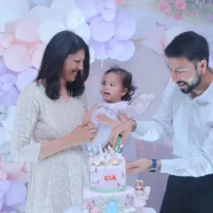 The cake cutting is a classic milestone, and we make sure to capture it with all the excitement and love in the room. This is a memory of a family celebrating their daughter's first birthday together.