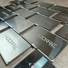 Duplicate of 56. A bulk order of sleek, brushed metal card holders, each engraved with the "Corre Group" logo. These make for a professional and practical corporate gift.