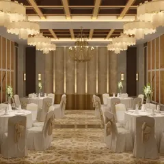 The banquet hall at Centre Point, Nagpur, designed for elegance and versatility. The space features a coffered ceiling with grand chandeliers, neutral-toned walls, and plush carpeting to create a luxurious setting for any event.