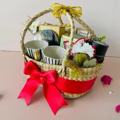 Another view of the Kauna oval basket, showing the beautiful striped ceramic mugs and other premium items nestled inside.