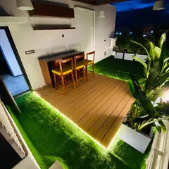 The terrace at night, where integrated LED strip lighting along the wooden deck creates a warm and inviting ambiance. This highlights how thoughtful lighting design can completely change the mood of an outdoor space.