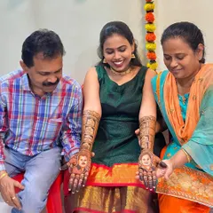 The bride's parents admiring the henna portraits of themselves on their daughter's hands. These moments are what make personalized mehendi so special.