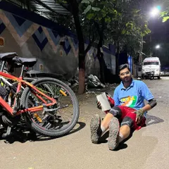 After a small fall, one of our riders takes a moment to rest and demonstrate some post-cycling stretches right on the road. It's a reminder that bruises happen, but they also make for good stories.